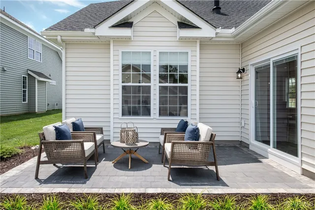 a view of a patio with couches chairs and potted plants