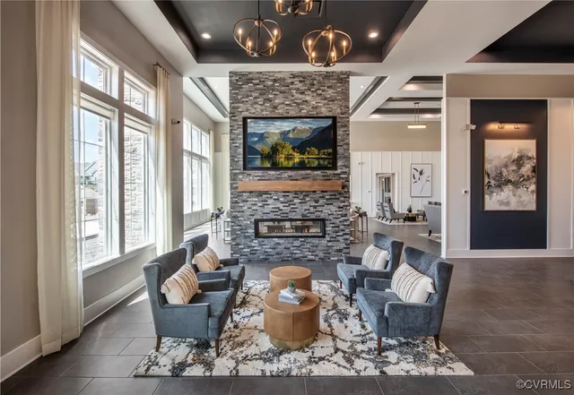 a living room with furniture a fireplace and wooden floor