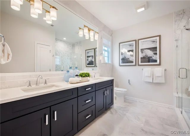 a spacious bathroom with a double vanity sink a large mirror and a bathtub