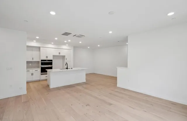 a view of kitchen with kitchen island stainless steel appliances sink and stove