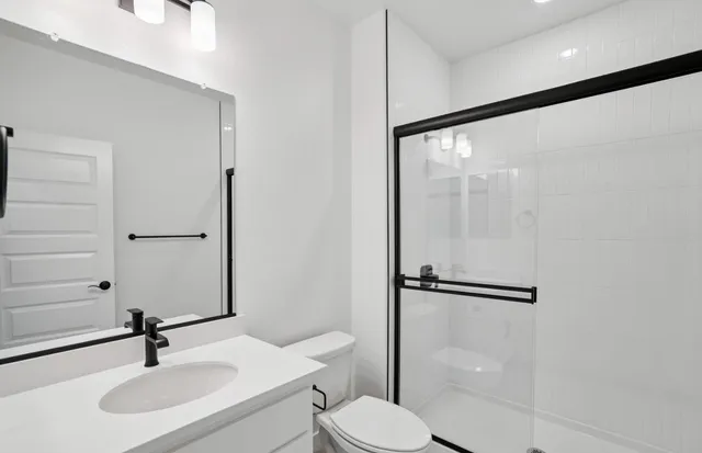 a bathroom with a sink toilet and shower