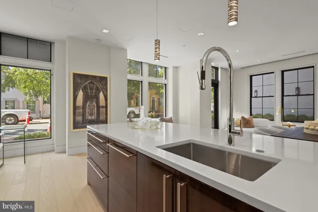 a kitchen with counter top a sink and cabinets