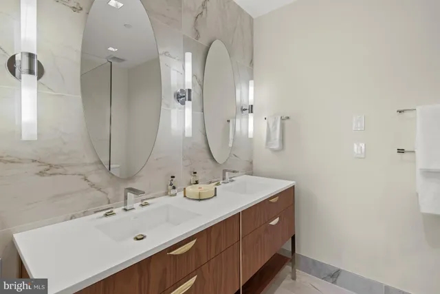 a bathroom with a double vanity sink and a mirror