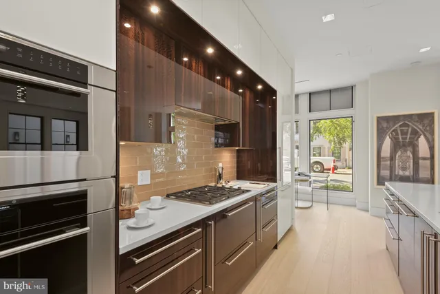 a kitchen with stainless steel appliances kitchen island granite countertop a stove and a refrigerator