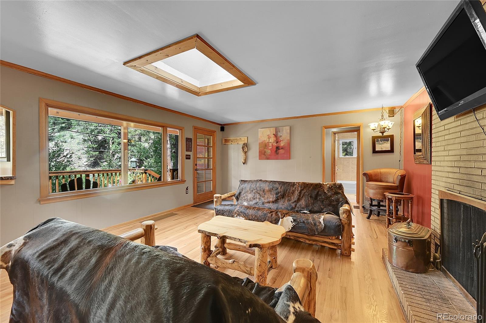 14432 South Elk Creek Road Pine, CO 80470 - Photo 30 of 50 a living room with furniture and a flat screen tv