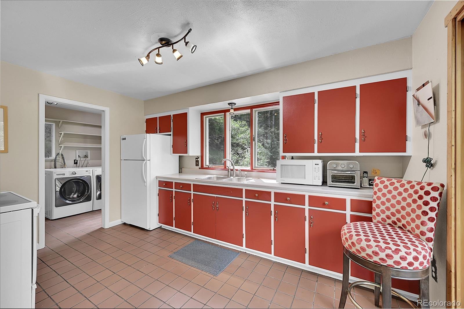 14432 South Elk Creek Road Pine, CO 80470 - Photo 37 of 50 a open kitchen with stainless steel appliances granite countertop a stove and a sink
