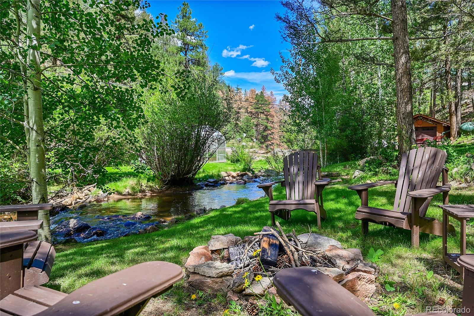 14432 South Elk Creek Road Pine, CO 80470 - Photo 9 of 50 a view of backyard with outdoor seating and green space