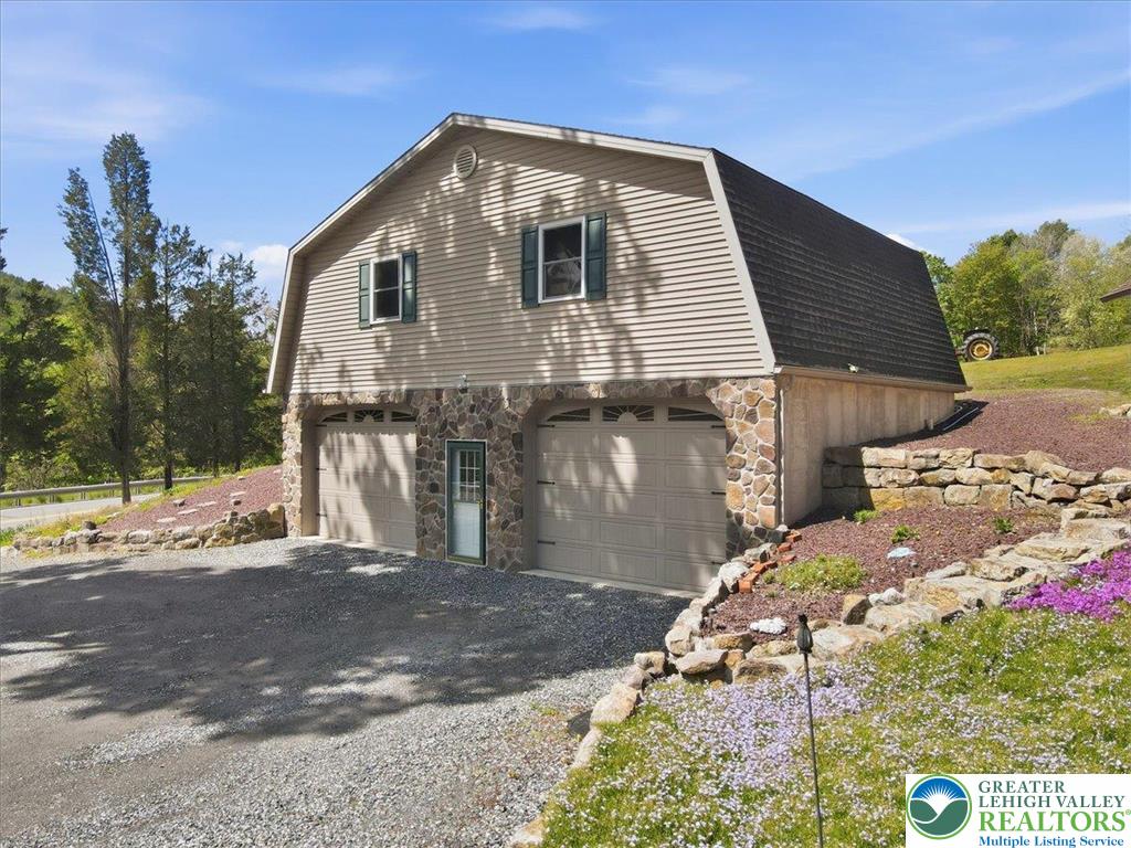 4880 Little Gap Road Kunkletown, PA 18058 - Photo 56 of 100 This structure features a unique gambrel roof and stone accents, offering versatile space.