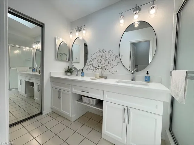 a bathroom with a double vanity sink and a mirror