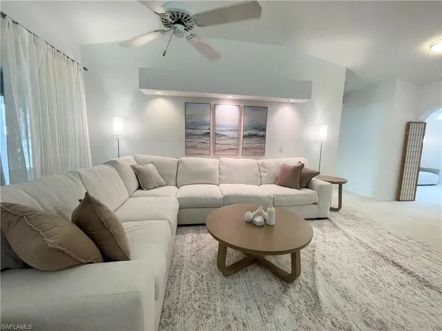 a living room with furniture and a lamp