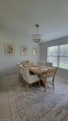 a dining room with a wooden table and chairs