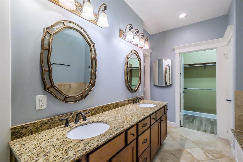 706 Allston Street, Unit B Houston, TX 77007 - Photo 15 of 33 a bathroom with a granite countertop double vanity sink and a mirror
