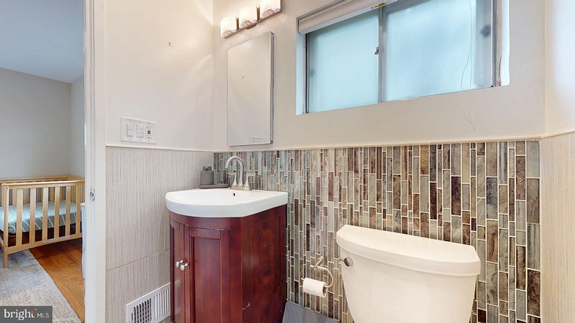 6334 Alberta Street Springfield, VA 22152 - Photo 11 of 28 a bathroom with a toilet a sink and a mirror