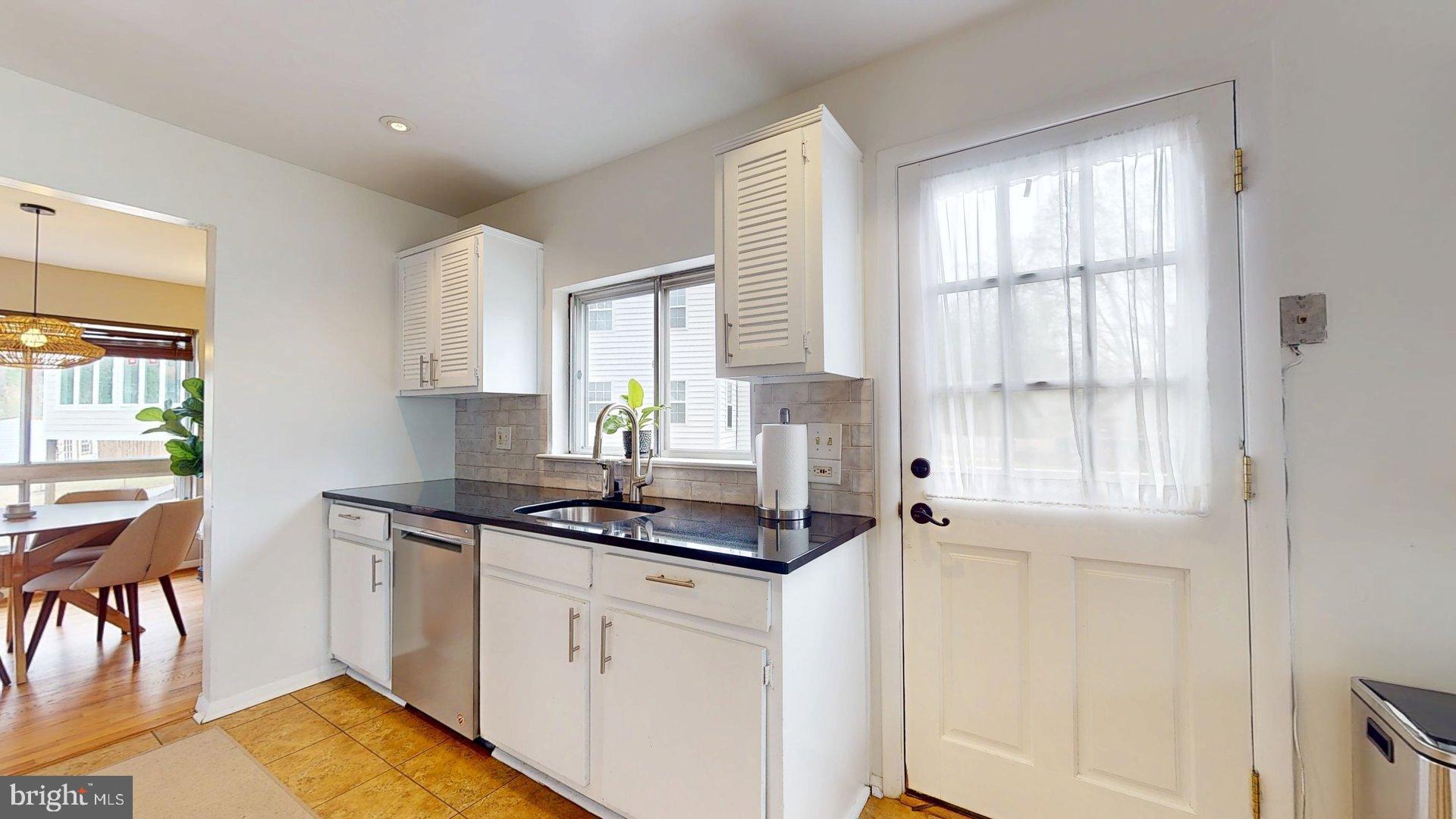 6334 Alberta Street Springfield, VA 22152 - Photo 7 of 28 a kitchen with stainless steel appliances granite countertop a sink stove and cabinets