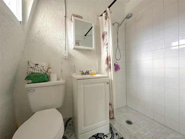 a bathroom with a toilet a sink and shower
