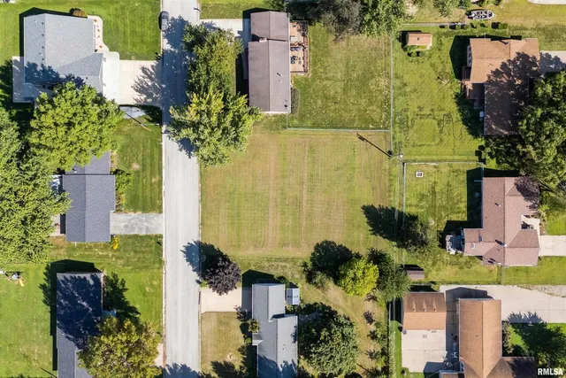 an aerial view of a residential apartment building with a yard