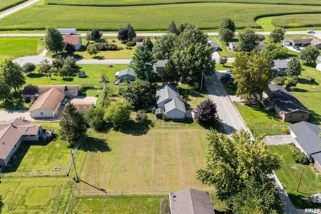 an aerial view of a house with a yard swimming pool and outdoor seating