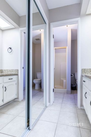 732 South Chesapeake Street Ridgecrest, CA 93555 - Photo 19 of 28 a bathroom with a granite countertop sink mirror and toilet