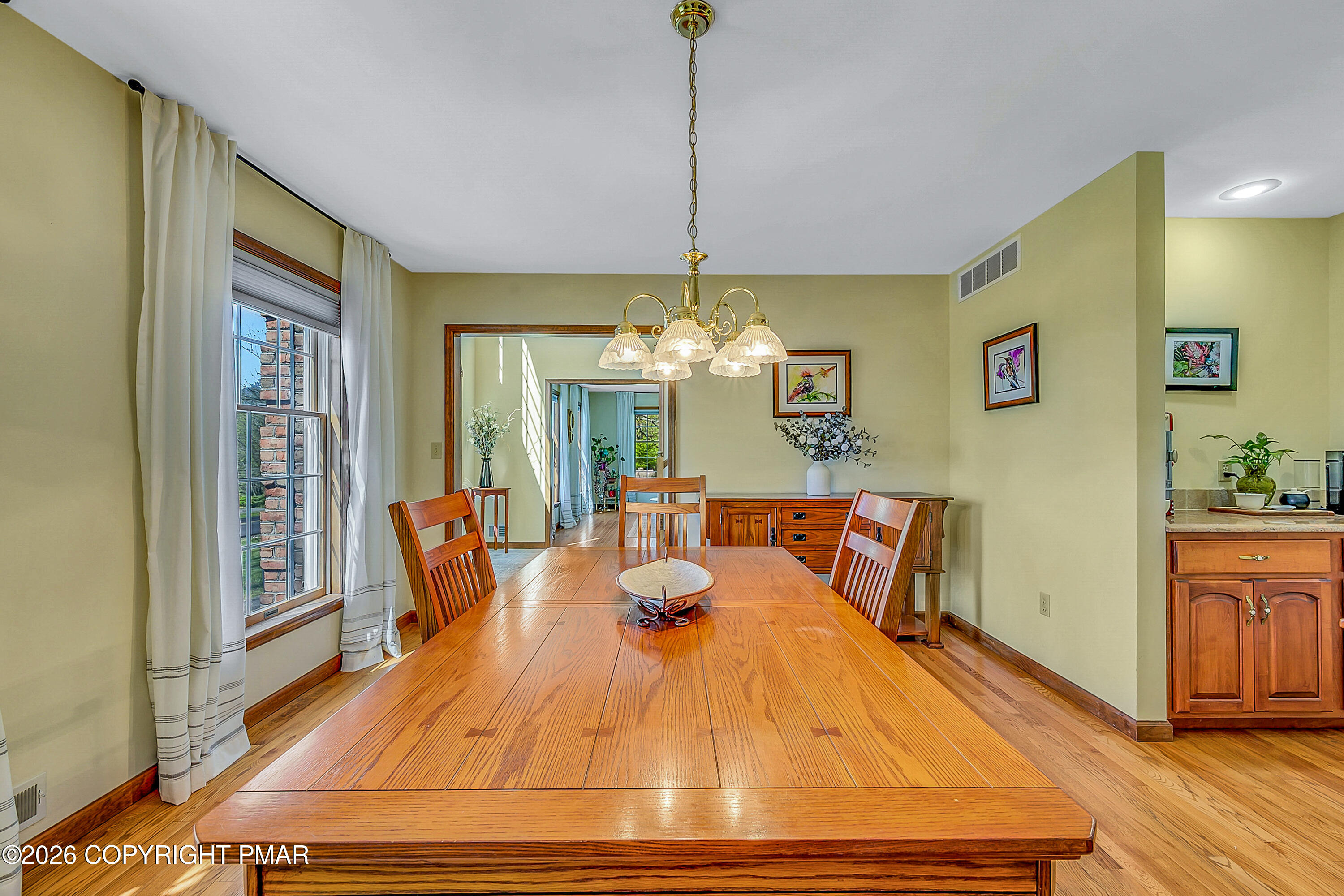 207 Smiley Lane Stroudsburg, PA 18360 - Photo 17 of 85 a dining room with wooden floor a chandelier a glass table and chairs