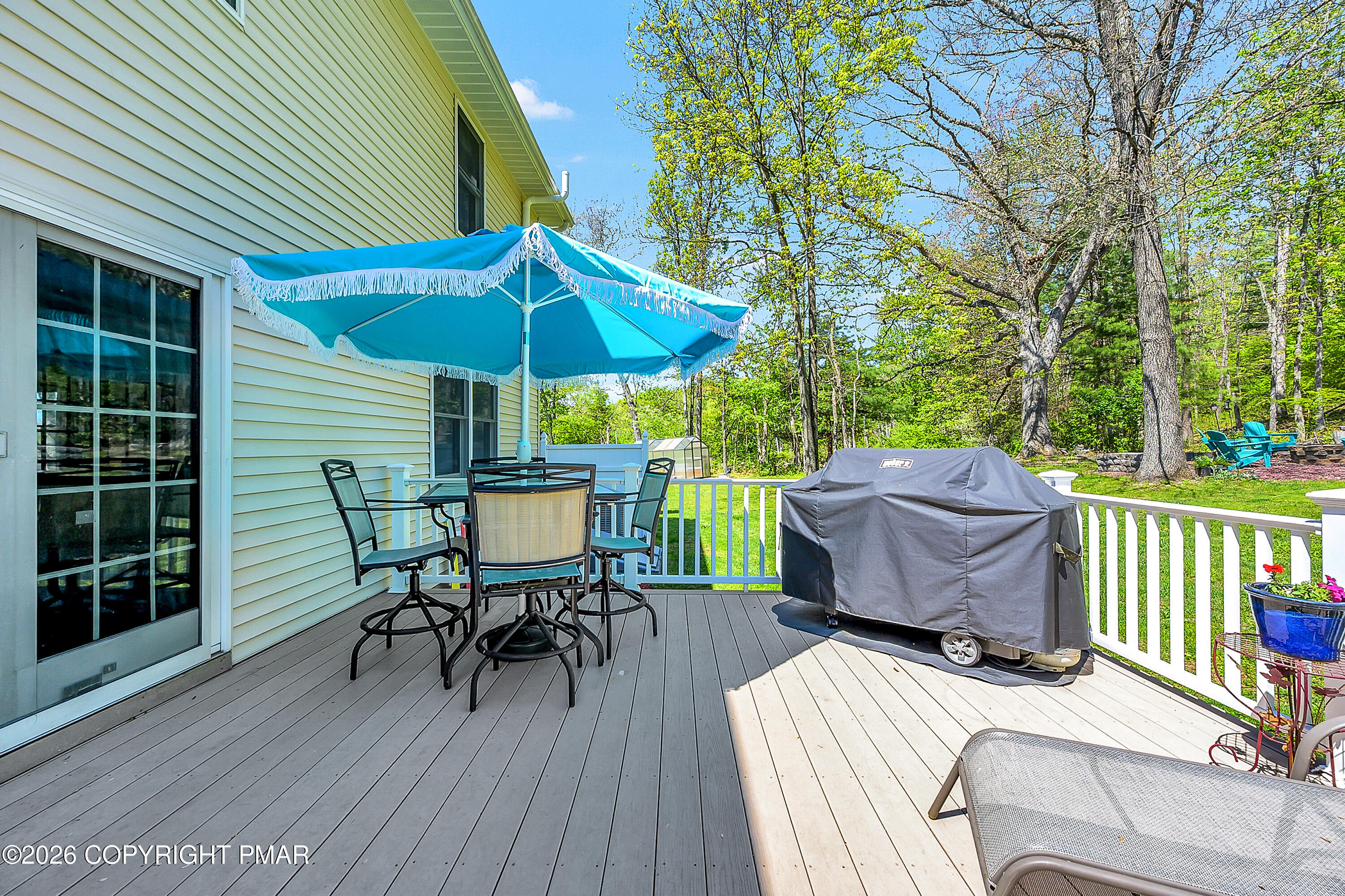 207 Smiley Lane Stroudsburg, PA 18360 - Photo 26 of 85 a view of a patio with table and chairs and wooden floor