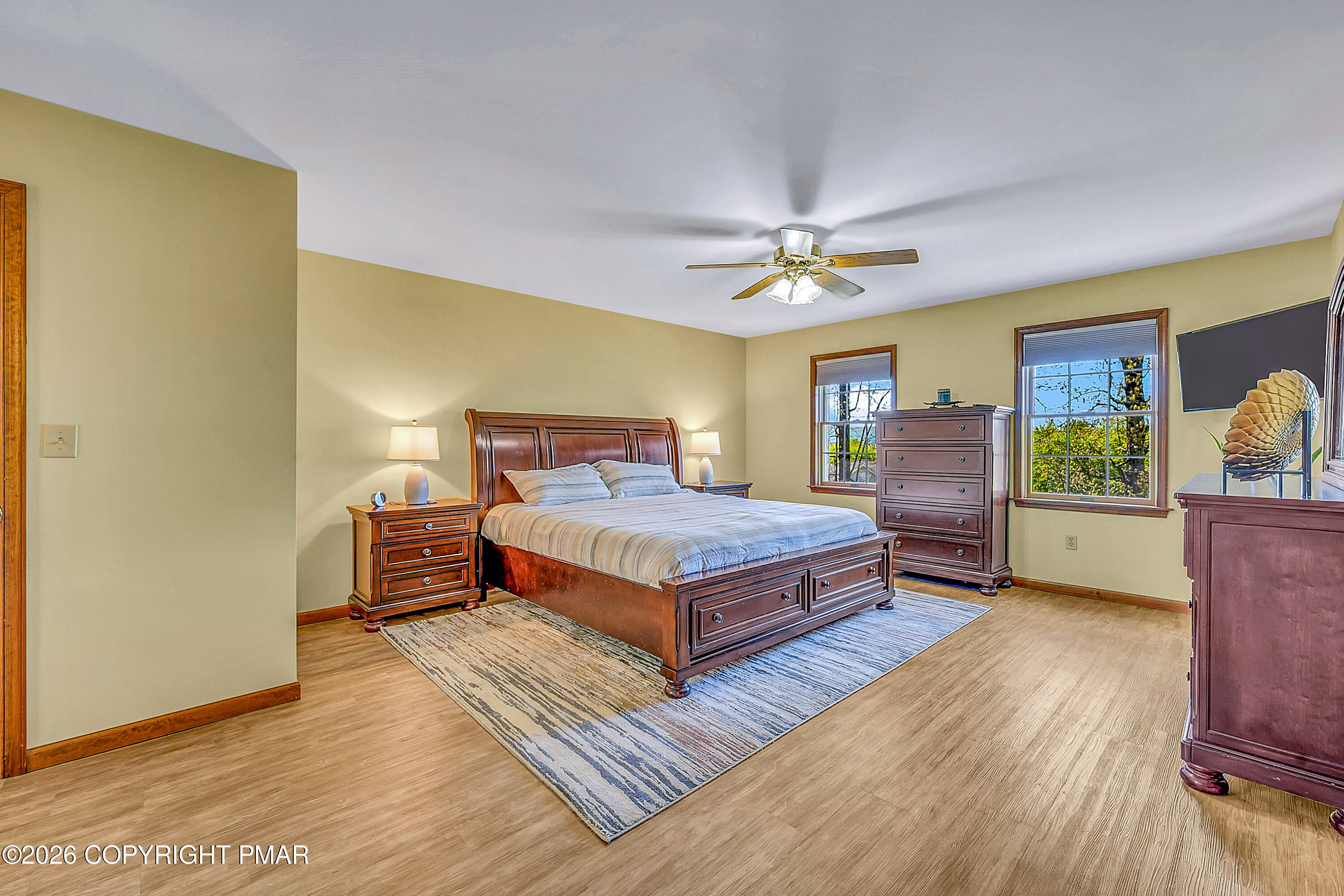 207 Smiley Lane Stroudsburg, PA 18360 - Photo 29 of 85 a bedroom with a large bed a chandelier and dresser