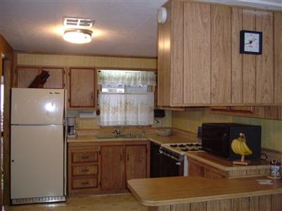 294 Yosemite Road, Unit 294 San Rafael, CA 94903 - Photo 3 of 7 a kitchen with stainless steel appliances granite countertop a refrigerator a stove and a sink with wooden cabinets