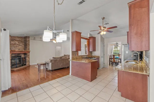 a living room with fireplace furniture and a wooden floor