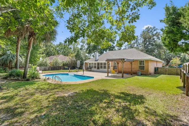 a view of a house with swimming pool and yard