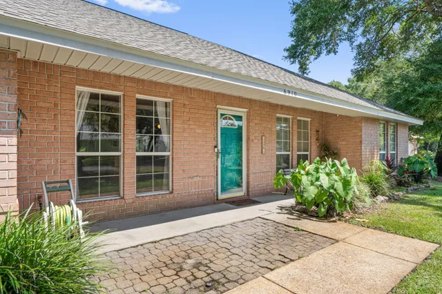 a house with potted plants in front of door