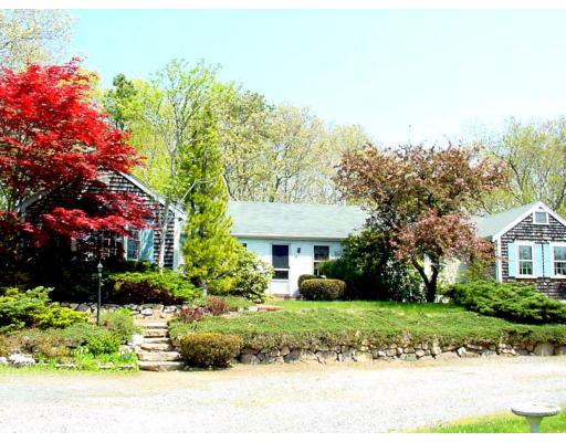 26 Indian Neck Road Wareham, MA 02571 - Photo 1 of 4 a front view of a house with a yard and potted plants