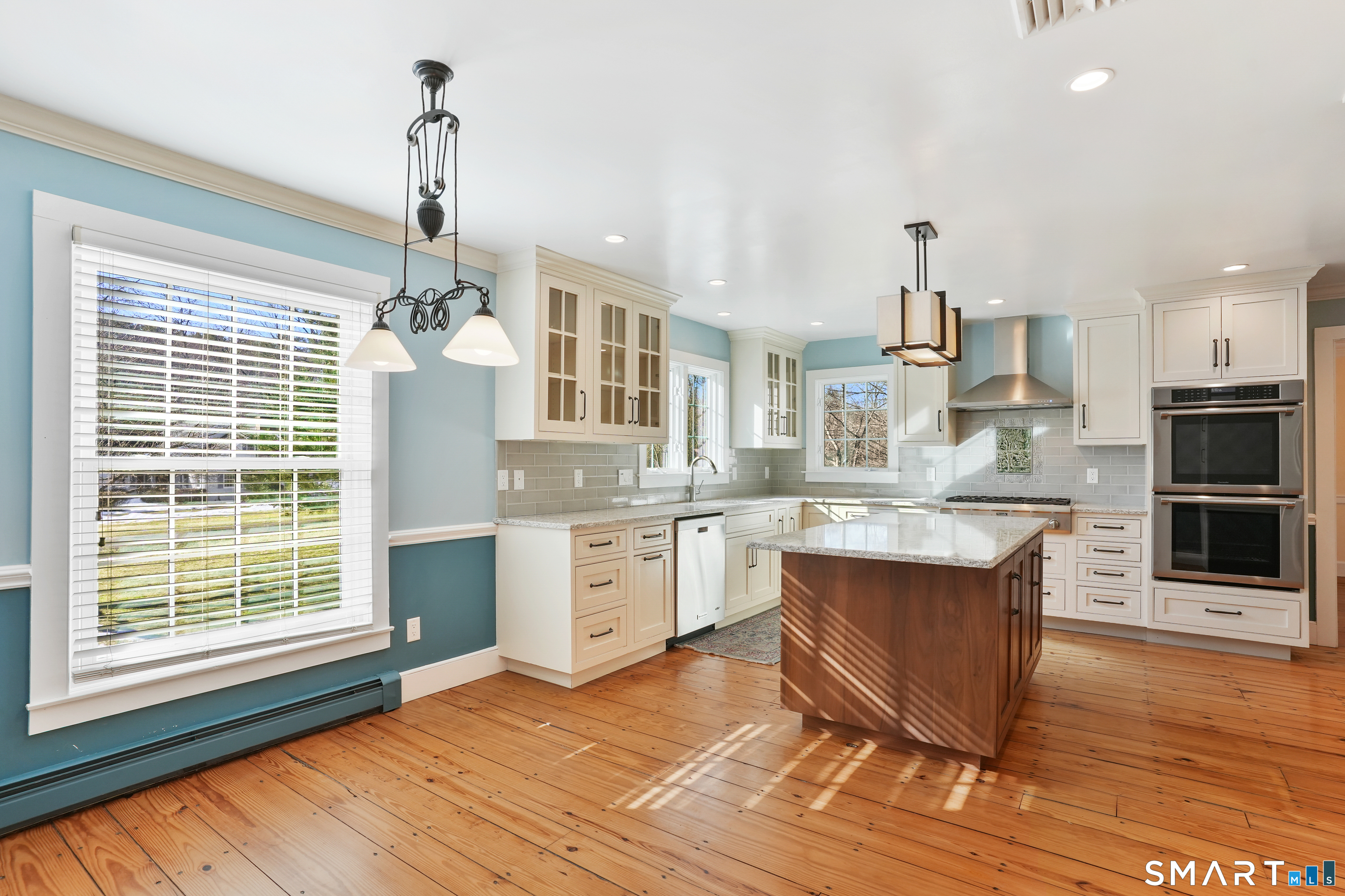 297 Long Mountain Road New Milford, CT 06776 - Photo 11 of 40 a large kitchen with granite countertop a stove and a wooden floors
