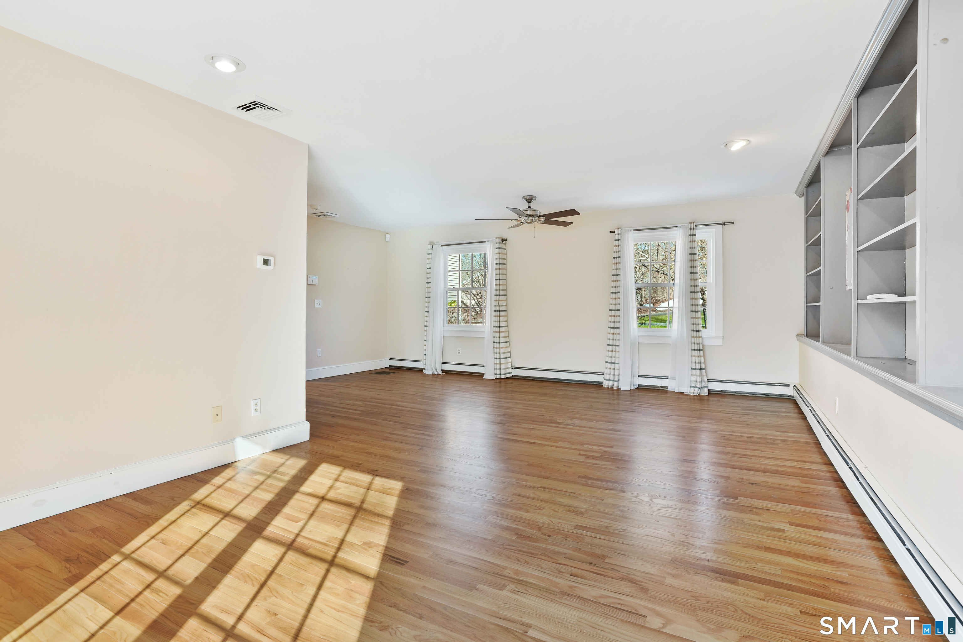 297 Long Mountain Road New Milford, CT 06776 - Photo 14 of 40 an empty room with wooden floor and windows