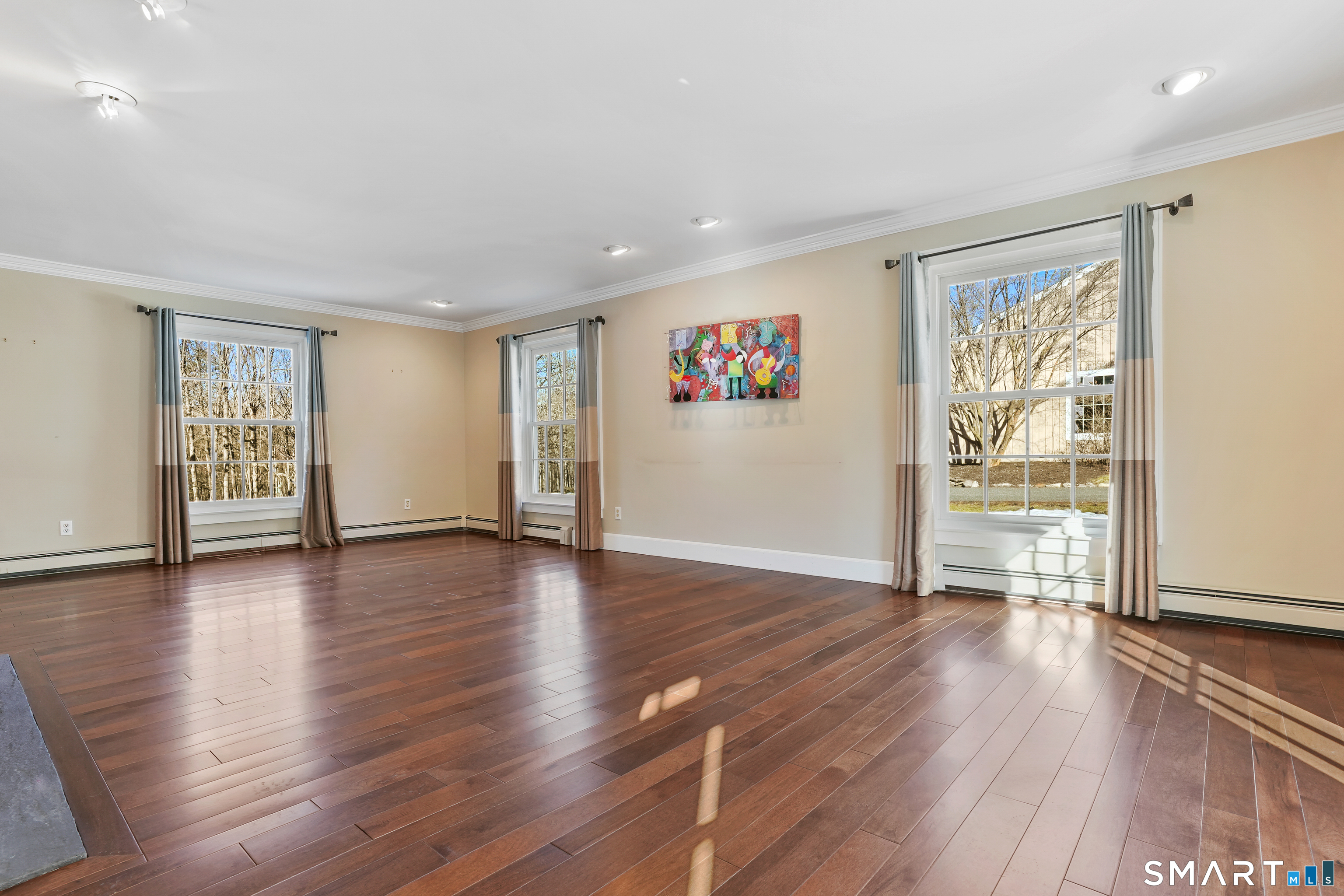 297 Long Mountain Road New Milford, CT 06776 - Photo 18 of 40 a view of an empty room with wooden floor and a window