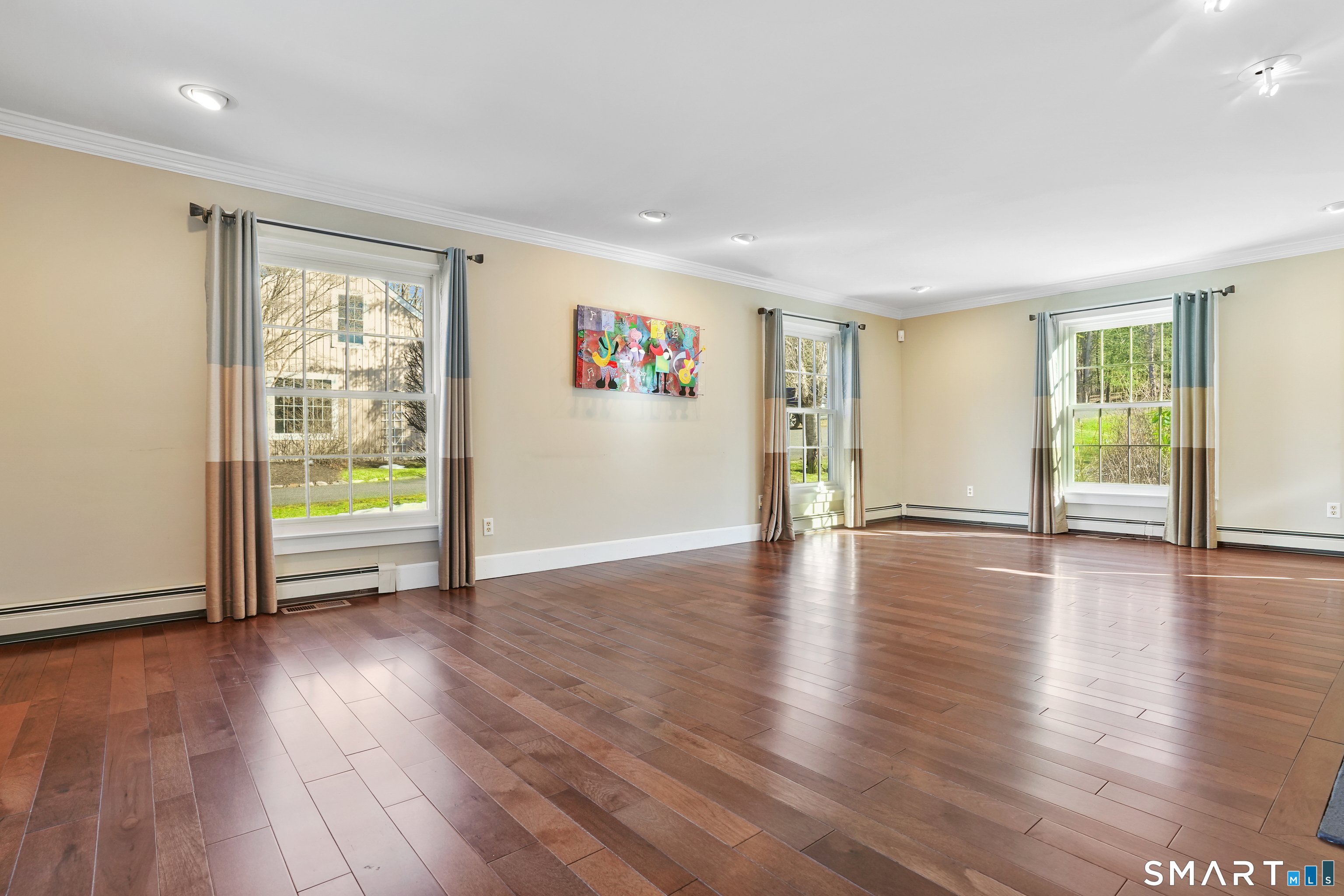 297 Long Mountain Road New Milford, CT 06776 - Photo 20 of 40 a view of an empty room with wooden floor and a window