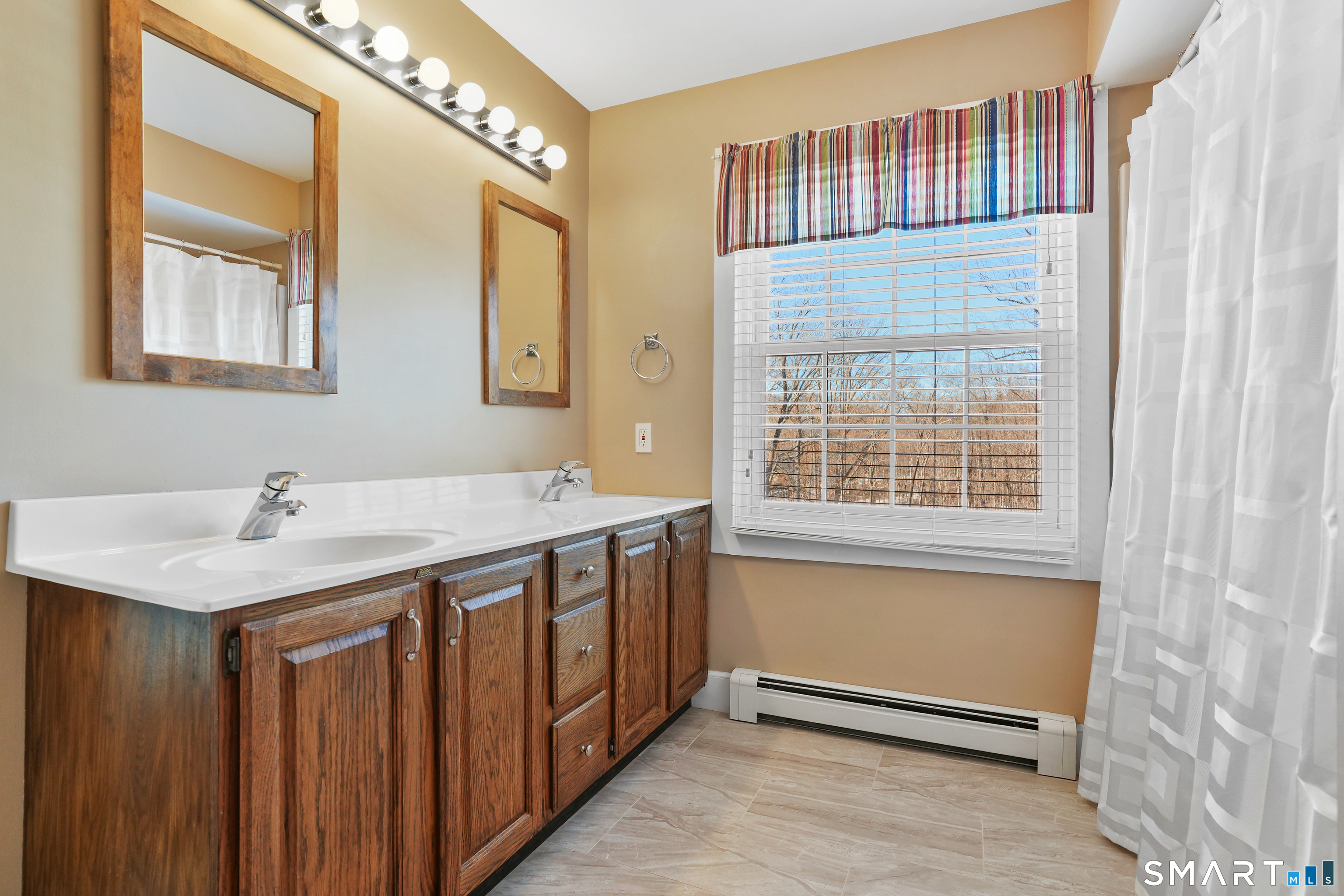 297 Long Mountain Road New Milford, CT 06776 - Photo 35 of 40 a bathroom with a sink and a mirror