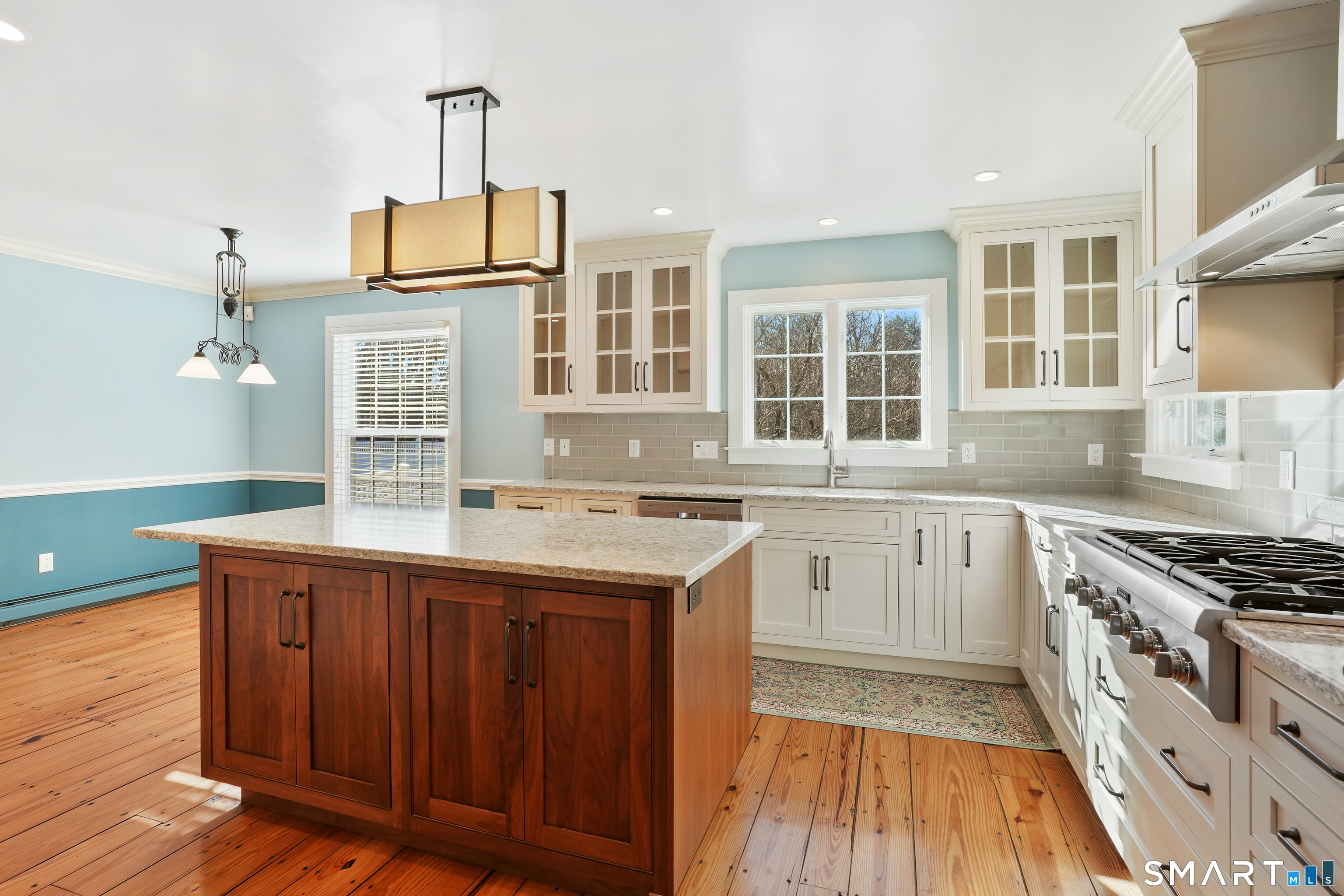 297 Long Mountain Road New Milford, CT 06776 - Photo 10 of 40 a kitchen with granite countertop a sink cabinets wooden floor and stainless steel appliances