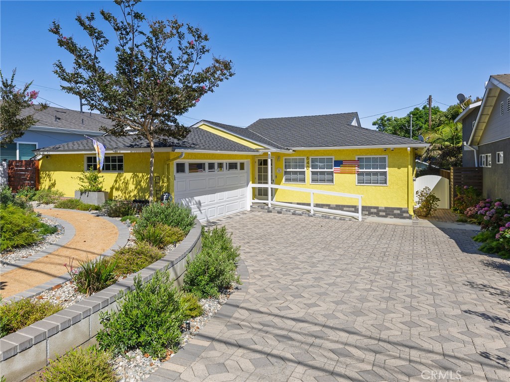 a front view of a house with a yard and a garage