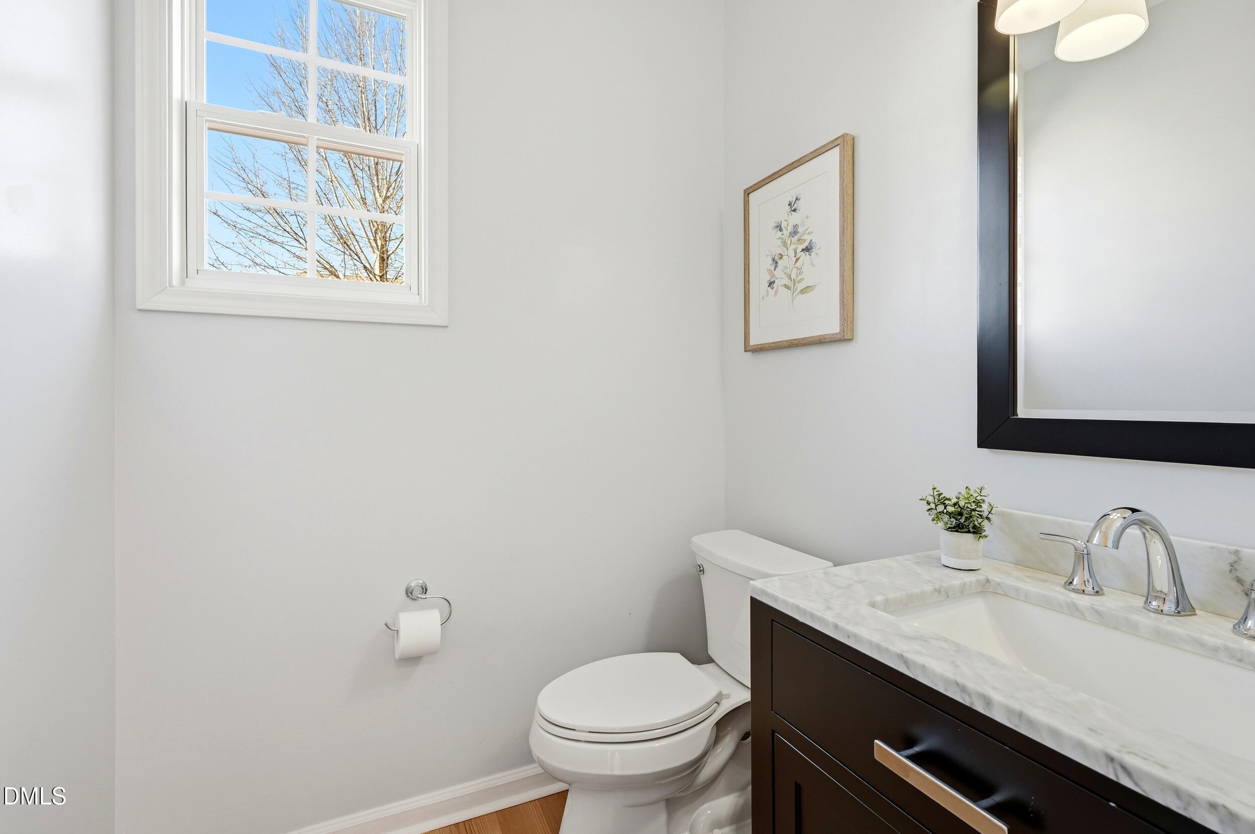 5401 Onyx Mill Court Raleigh, NC 27616 - Photo 11 of 48 a bathroom with a granite countertop toilet and a sink