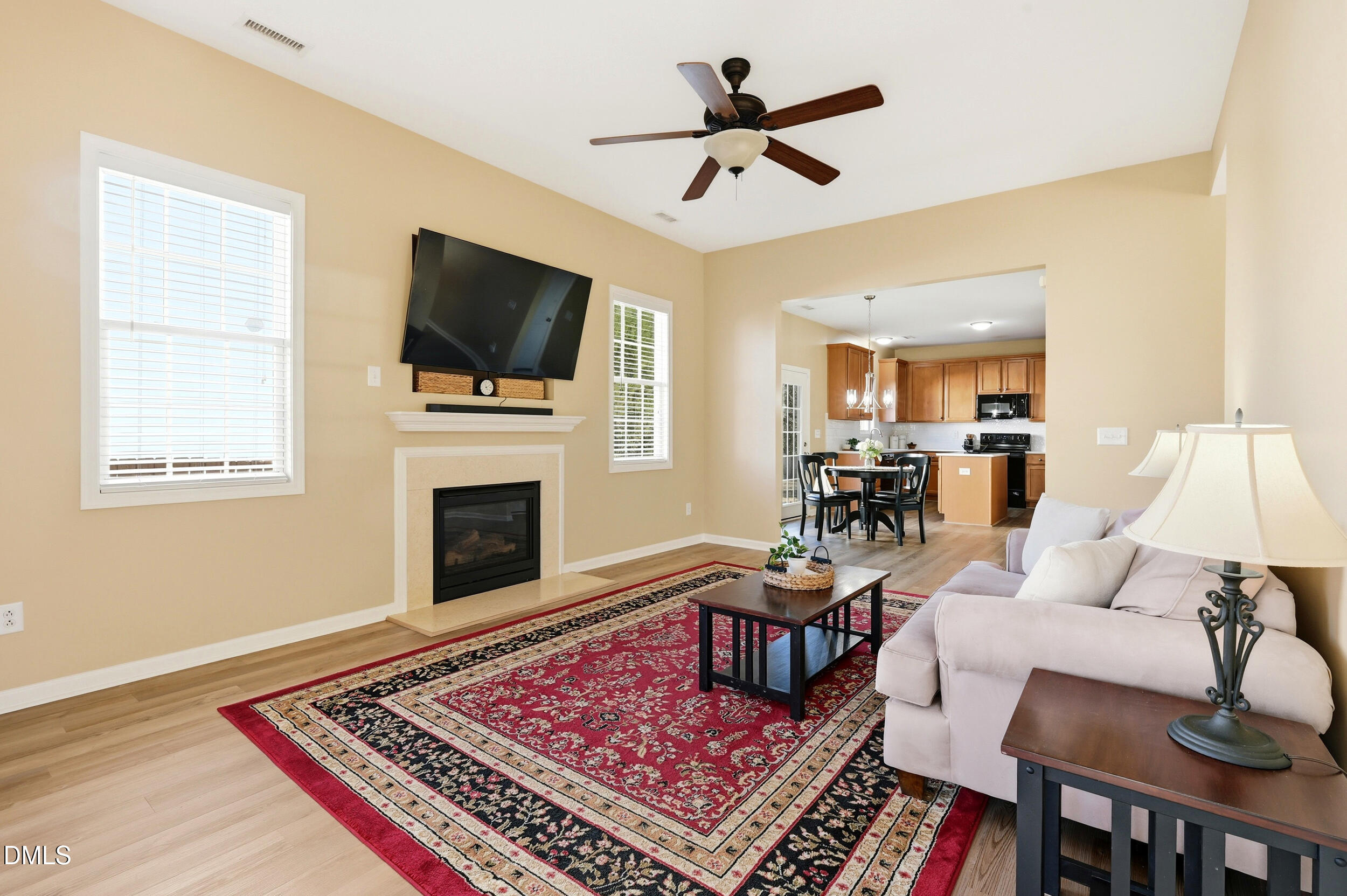 5401 Onyx Mill Court Raleigh, NC 27616 - Photo 14 of 48 a living room with furniture a flat screen tv and a fireplace