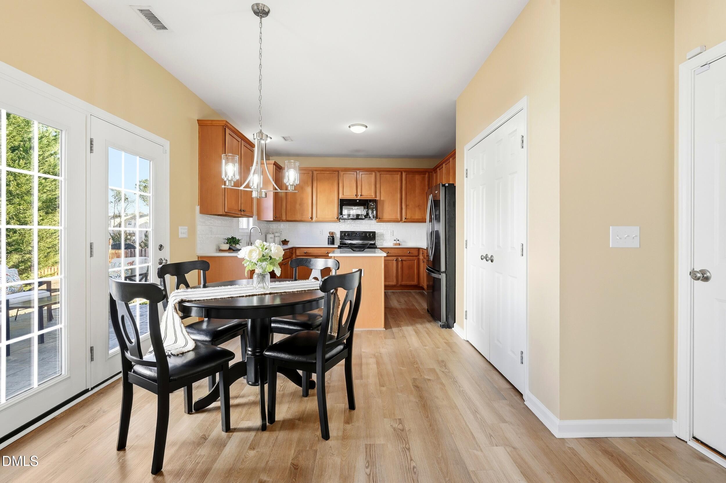 5401 Onyx Mill Court Raleigh, NC 27616 - Photo 18 of 48 a view of a dining room with furniture window and wooden floor