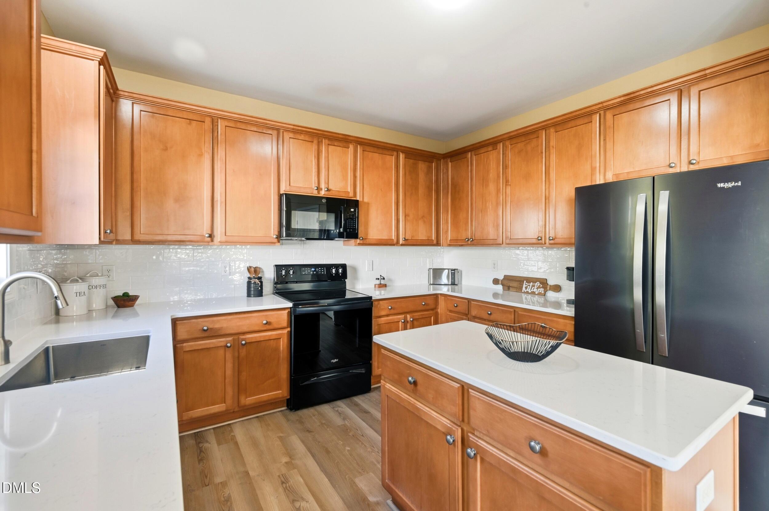 5401 Onyx Mill Court Raleigh, NC 27616 - Photo 20 of 48 a kitchen with stainless steel appliances granite countertop a refrigerator stove sink and cabinets
