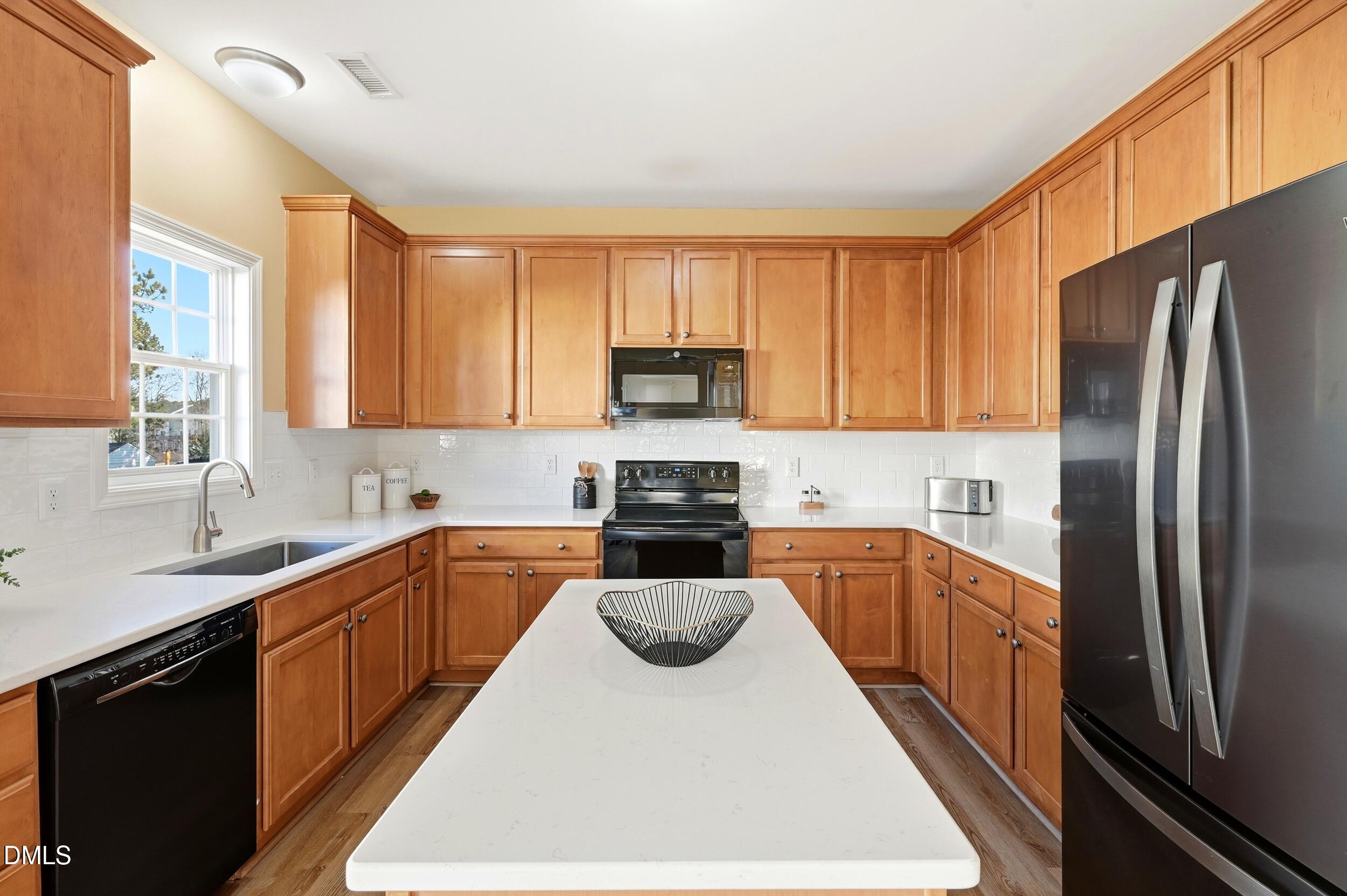 5401 Onyx Mill Court Raleigh, NC 27616 - Photo 21 of 48 a kitchen with a refrigerator sink and cabinets