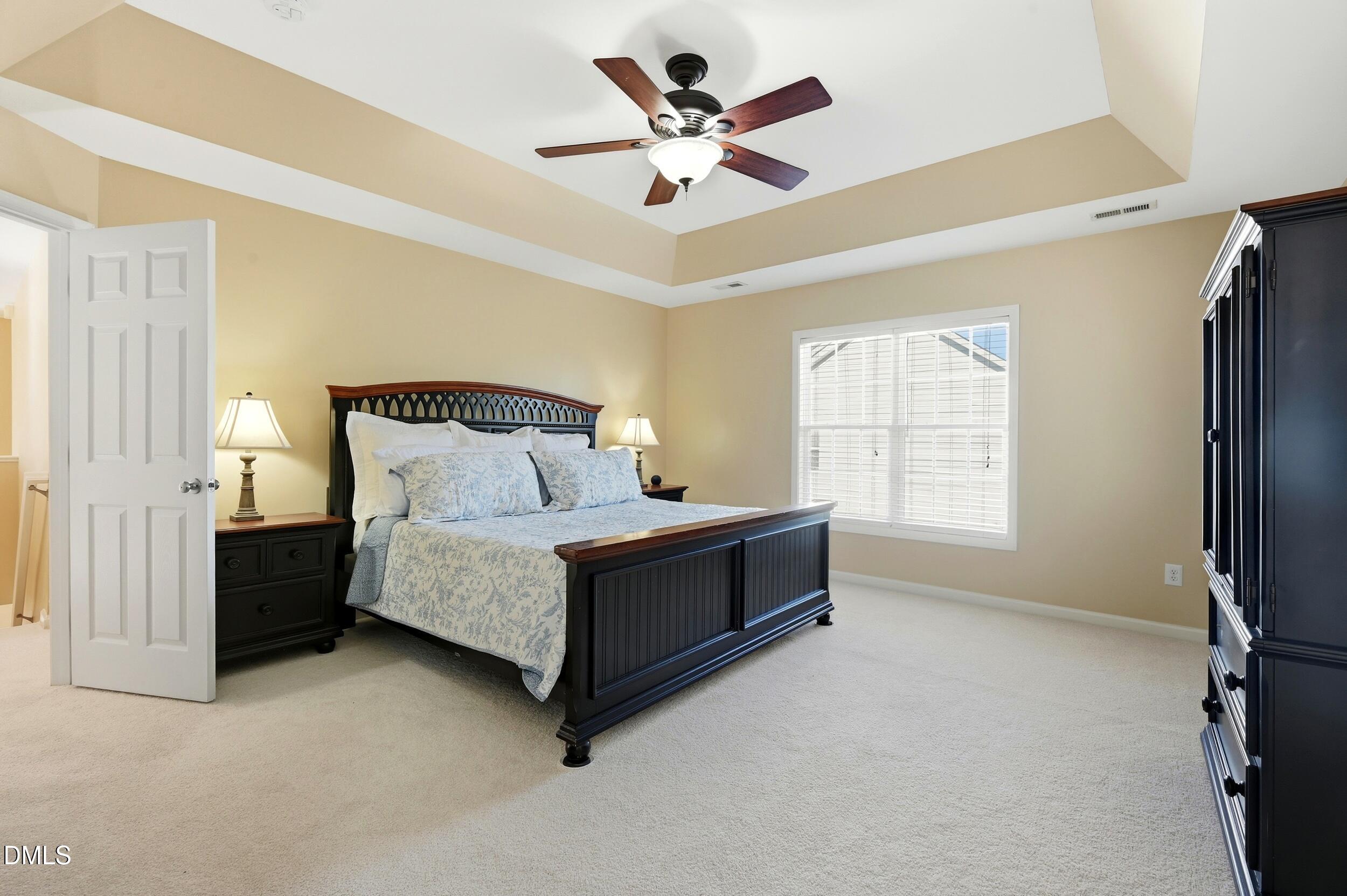 5401 Onyx Mill Court Raleigh, NC 27616 - Photo 25 of 48 a spacious bedroom with a bed and a ceiling fan