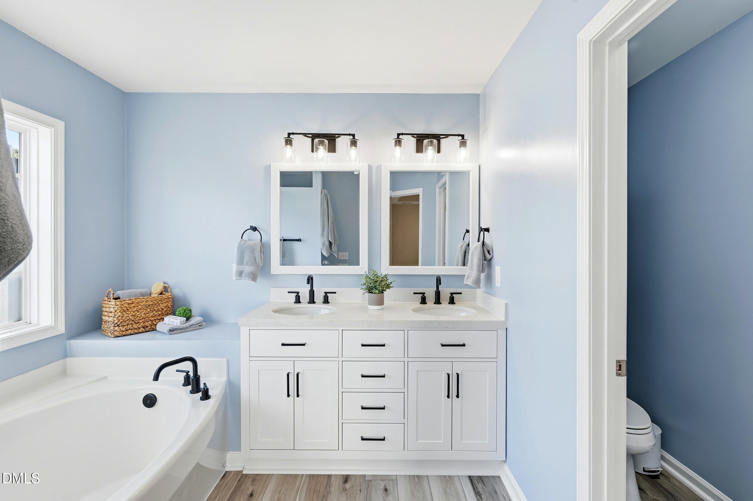 5401 Onyx Mill Court Raleigh, NC 27616 - Photo 28 of 48 a bathroom with a bathtub sink and mirror