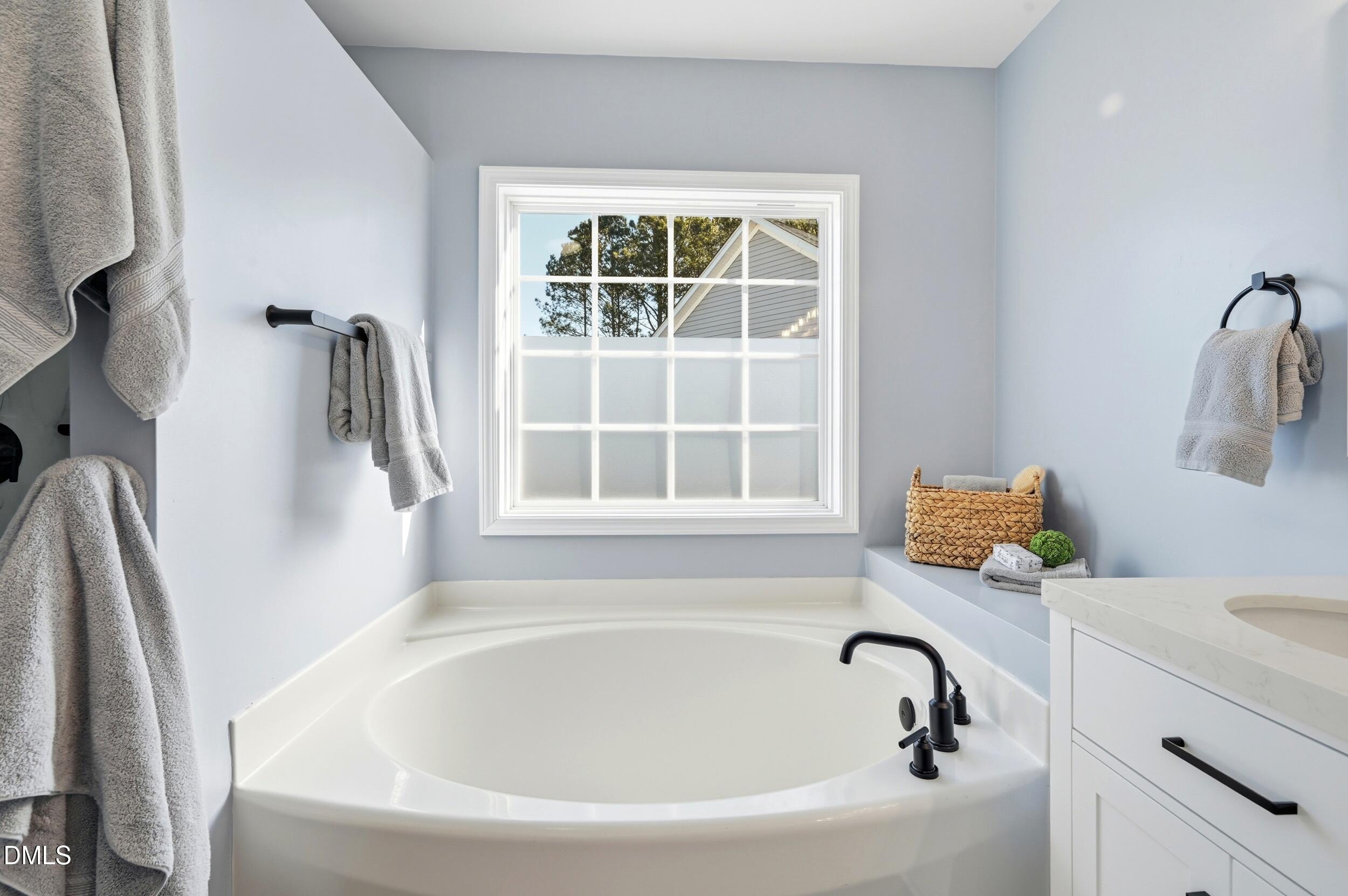 5401 Onyx Mill Court Raleigh, NC 27616 - Photo 30 of 48 a bathroom with bathtub and window