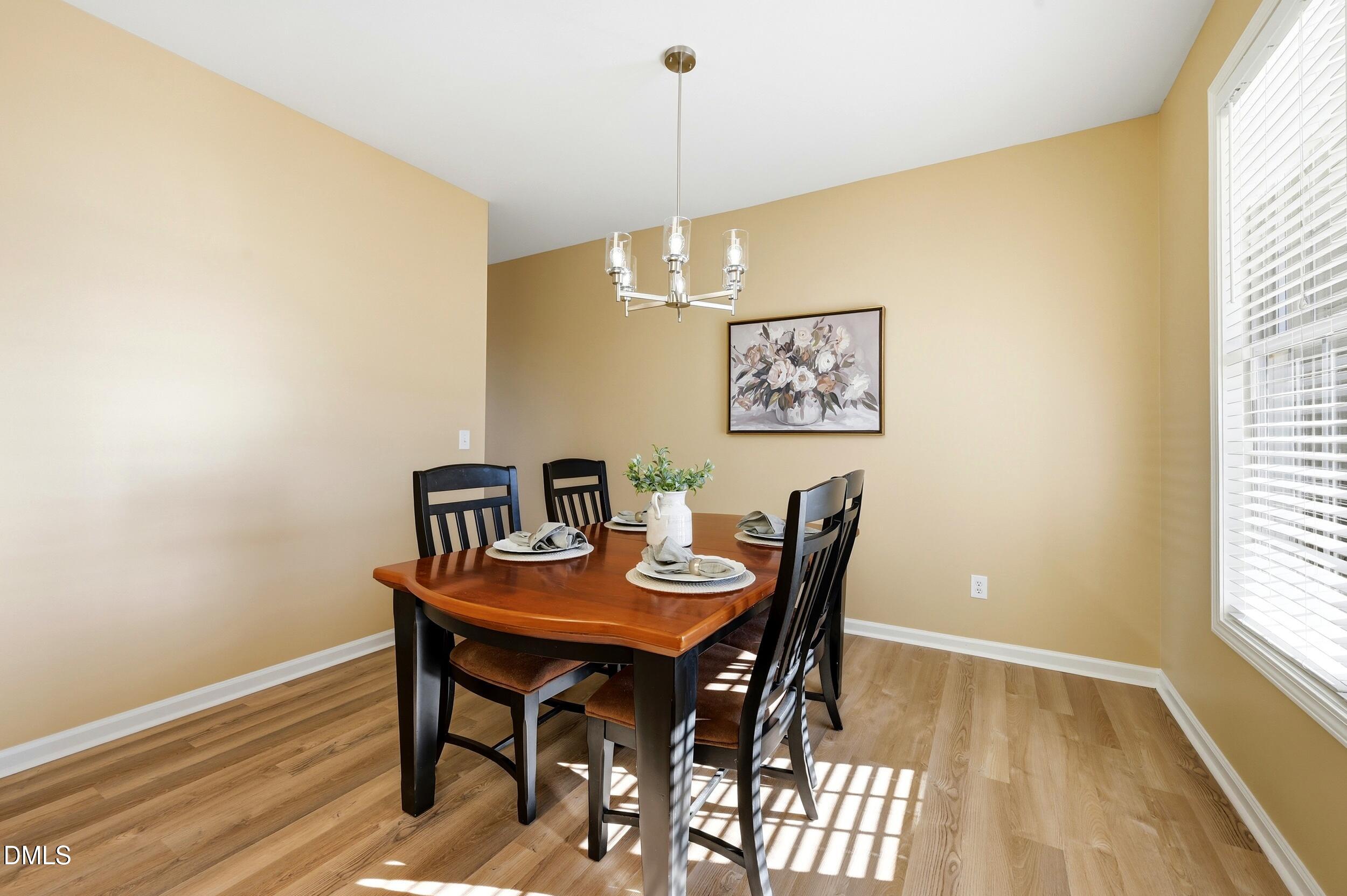 5401 Onyx Mill Court Raleigh, NC 27616 - Photo 6 of 48 a view of a dining room with furniture and wooden floor