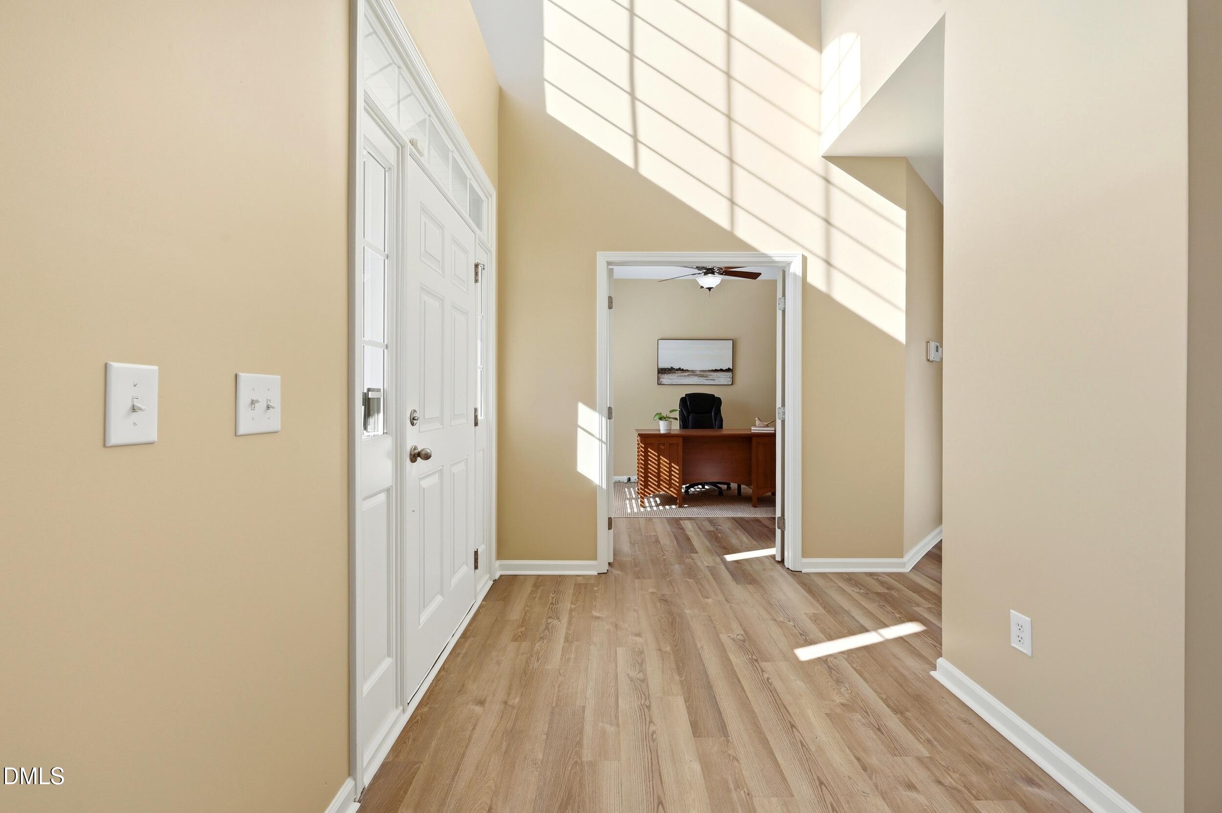 5401 Onyx Mill Court Raleigh, NC 27616 - Photo 7 of 48 a view of a hallway with wooden floor and a bathroom
