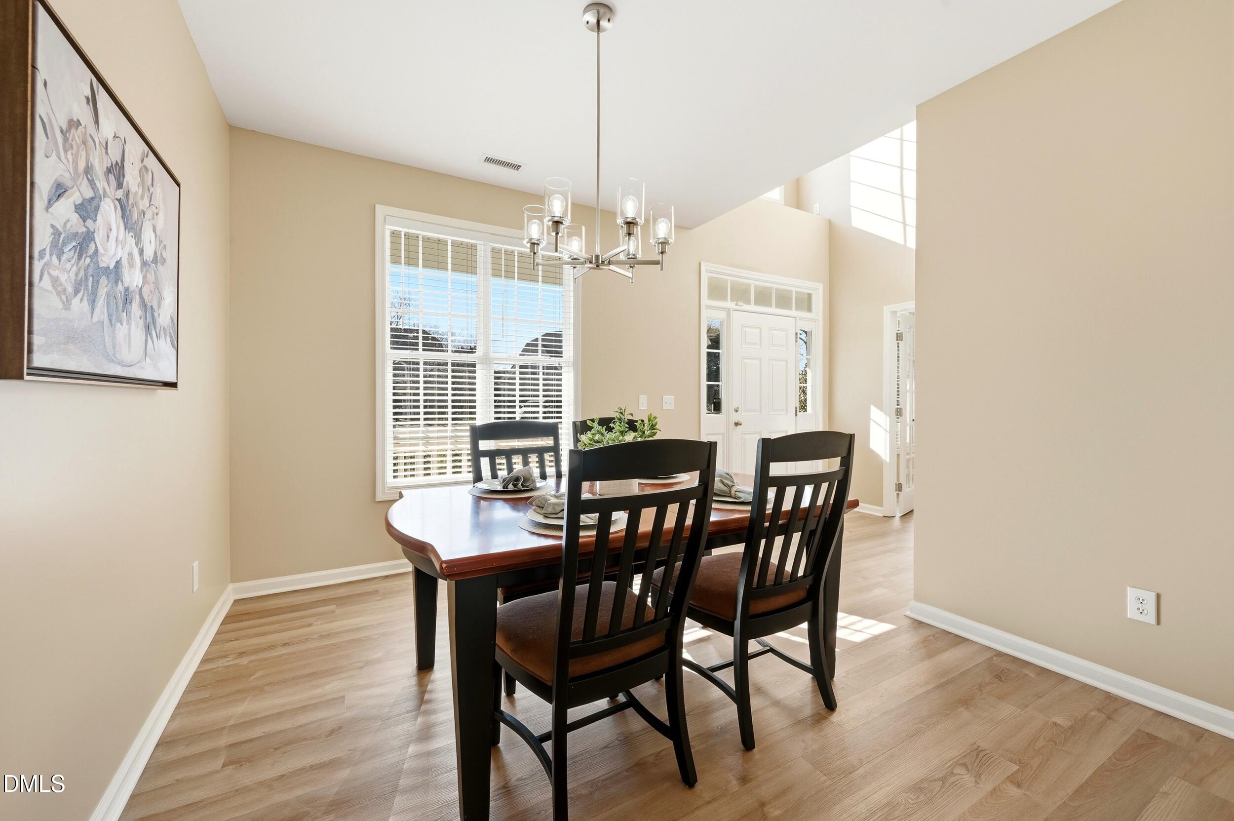 5401 Onyx Mill Court Raleigh, NC 27616 - Photo 8 of 48 a view of a dining room with furniture window and wooden floor