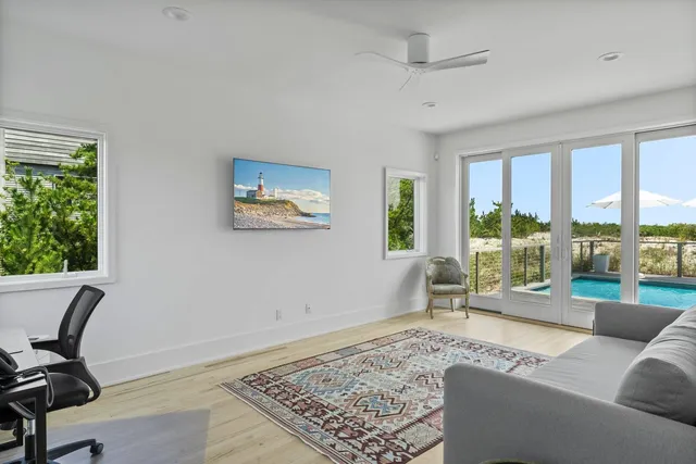 a living room with furniture and a floor to ceiling window