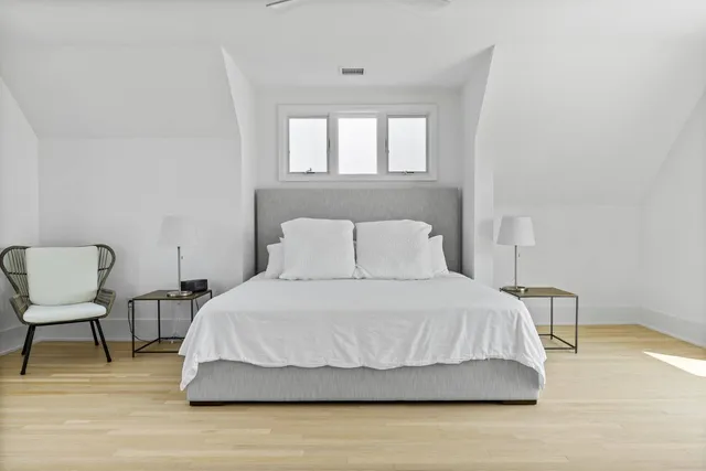 a bedroom with a bed and a chair